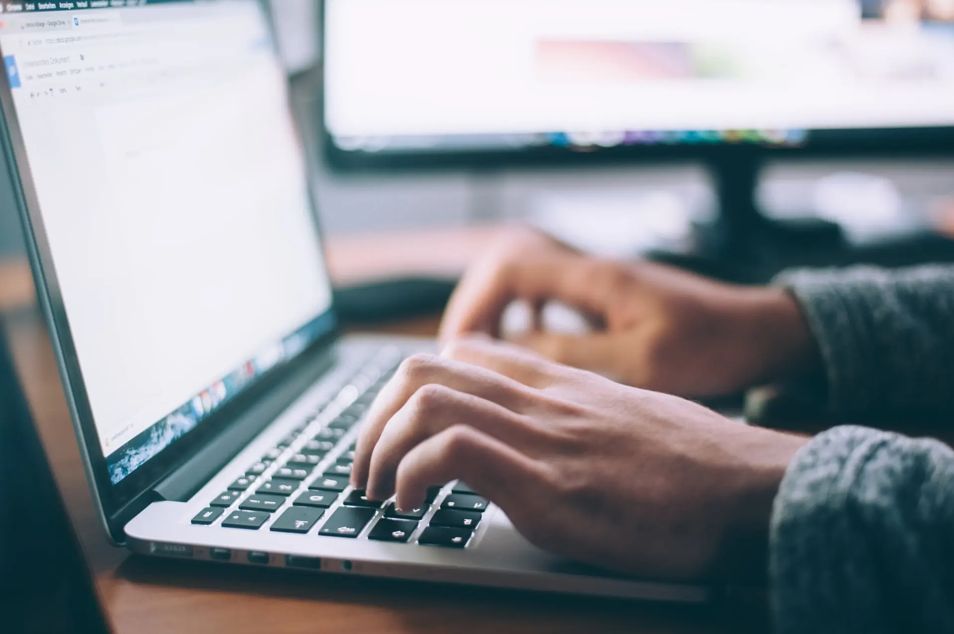 a person typing on a computer of tools